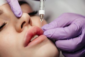 close up woman getting botox her lips